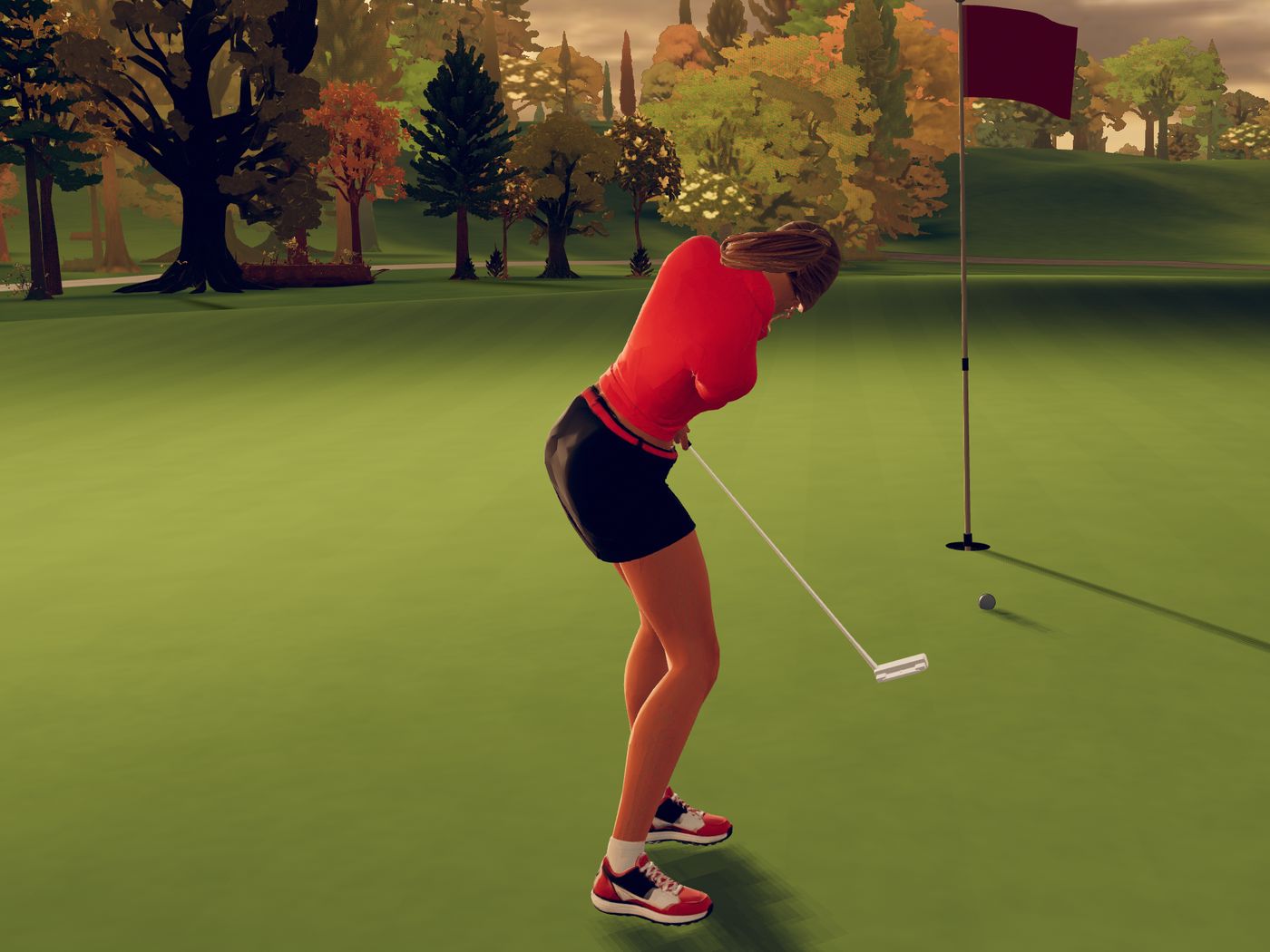 From behind, a blonde golfer in a coral polo holds her putting stroke as the ball rolls toward the cup, the flag and autumn trees beyond under a copper sky